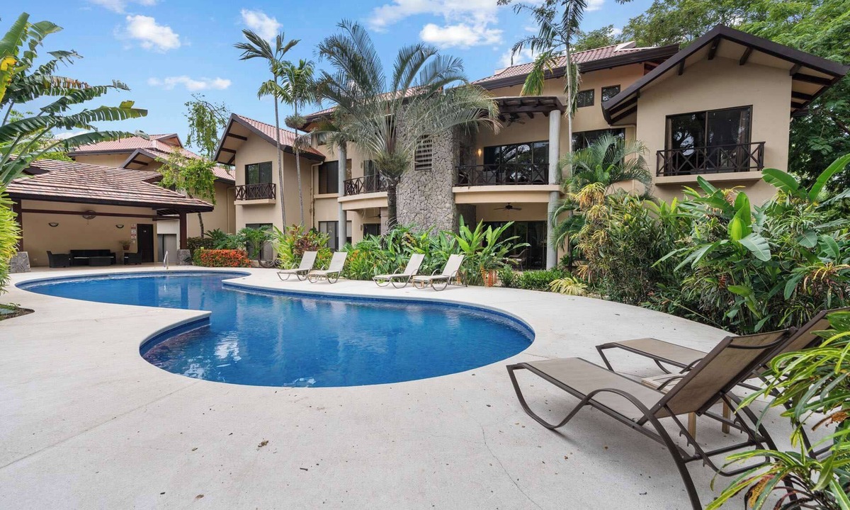 Coco Condo | Modern Island-Themed Condo with Floor-to-Ceiling Windows & Garden and Pool Views Within Walking Distance of the Beach
