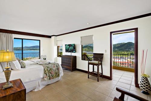 Playa Flamingo House | Remodeled Top-Floor Condo with Stunning Wrap-Around Balcony Offering Mountain, Ocean & Marina Views