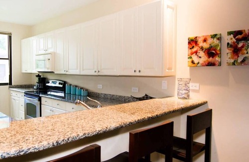 Coco Condo | Colorful Poolside Condo w/Garden-View Patio & Resort-Style Amenities
