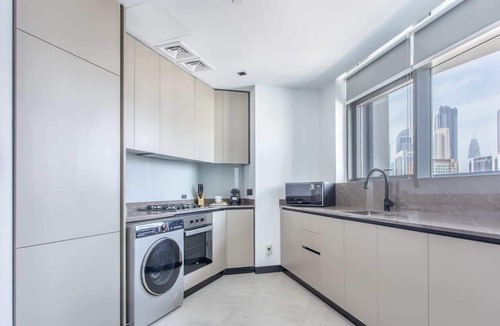 Business Bay Apartment | Cozy 2BR w/ Iconic Burj Khalifa & Canal Views!