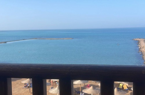 Village Road Apartment | G.3.11 Red Seafront apartment. Restaurant on beach, lounge chairs, umbrellas