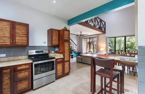 Coco Condo | Modern Island-Themed Condo with Floor-to-Ceiling Windows & Garden and Pool Views Within Walking Distance of the Beach