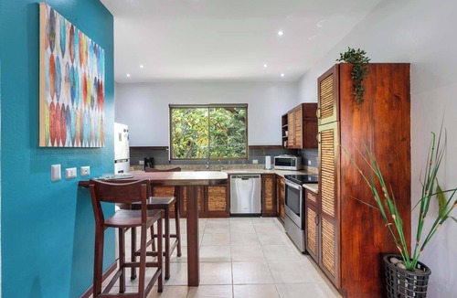 Coco Condo | Modern Island-Themed Condo with Floor-to-Ceiling Windows & Garden and Pool Views Within Walking Distance of the Beach