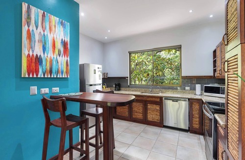 Coco Condo | Modern Island-Themed Condo with Floor-to-Ceiling Windows & Garden and Pool Views Within Walking Distance of the Beach