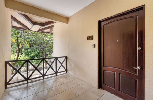 Coco Condo | Modern Island-Themed Condo with Floor-to-Ceiling Windows & Garden and Pool Views Within Walking Distance of the Beach