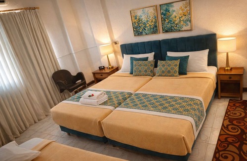 Luxor Hotel | Twin Room with King Bed Setup, Wi-Fi, AC & Private Bathroom