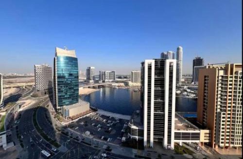 Madinat Zayed Apartment | Vogue Vacation Homes, Downtown Mag318 near Burj Khalifa and Dubai Mall, Studio Apartment with Balcony, Canal and City View, Access to all Amenities