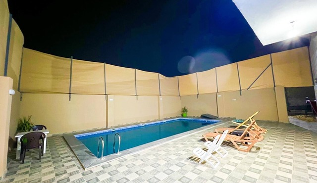 Cheerful two bedrooms villa with warm pool, playground,& specious sitting room.