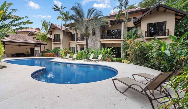 Modern Island-Themed Condo with Floor-to-Ceiling Windows & Garden and Pool Views Within Walking Distance of the Beach